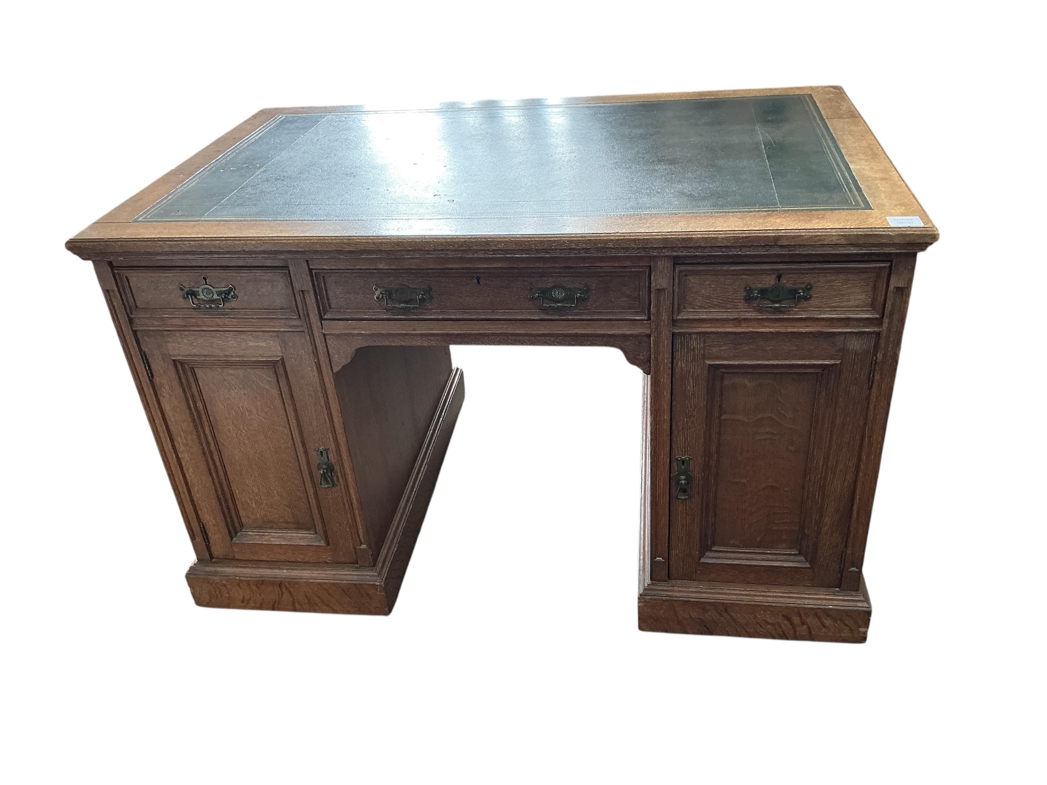 A late Victorian oak kneehole desk, width 122cm, depth 76cm, height 76cm